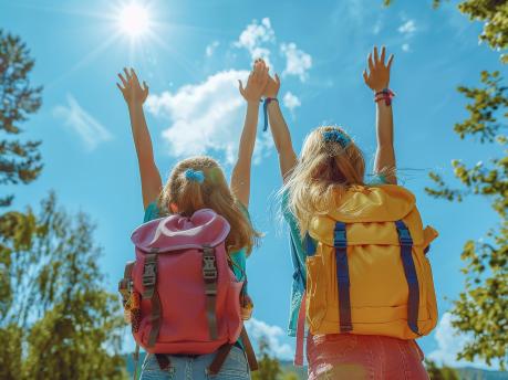 two-girls-with-backpacks-that-say-backpacks-sun-is-shining-them
