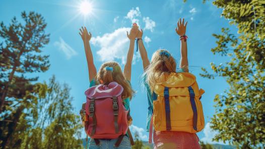 two-girls-with-backpacks-that-say-backpacks-sun-is-shining-them