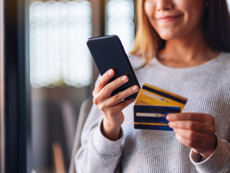 closeup-image-woman-using-credit-card-purchasing-shopping-online-mobile-phone